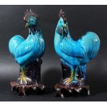 PAIR OF CHINESE COCKERELS, standing, with turquoise and magnanese glazing, on hardwood stand, height