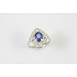 A SAPPHIRE AND DIAMOND CLUSTER RING the oval-shaped sapphire is set within a surround of four