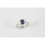 A SAPPHIRE AND DIAMOND THREE STONE RING the step-cut sapphire is set with two baguette-cut diamonds,