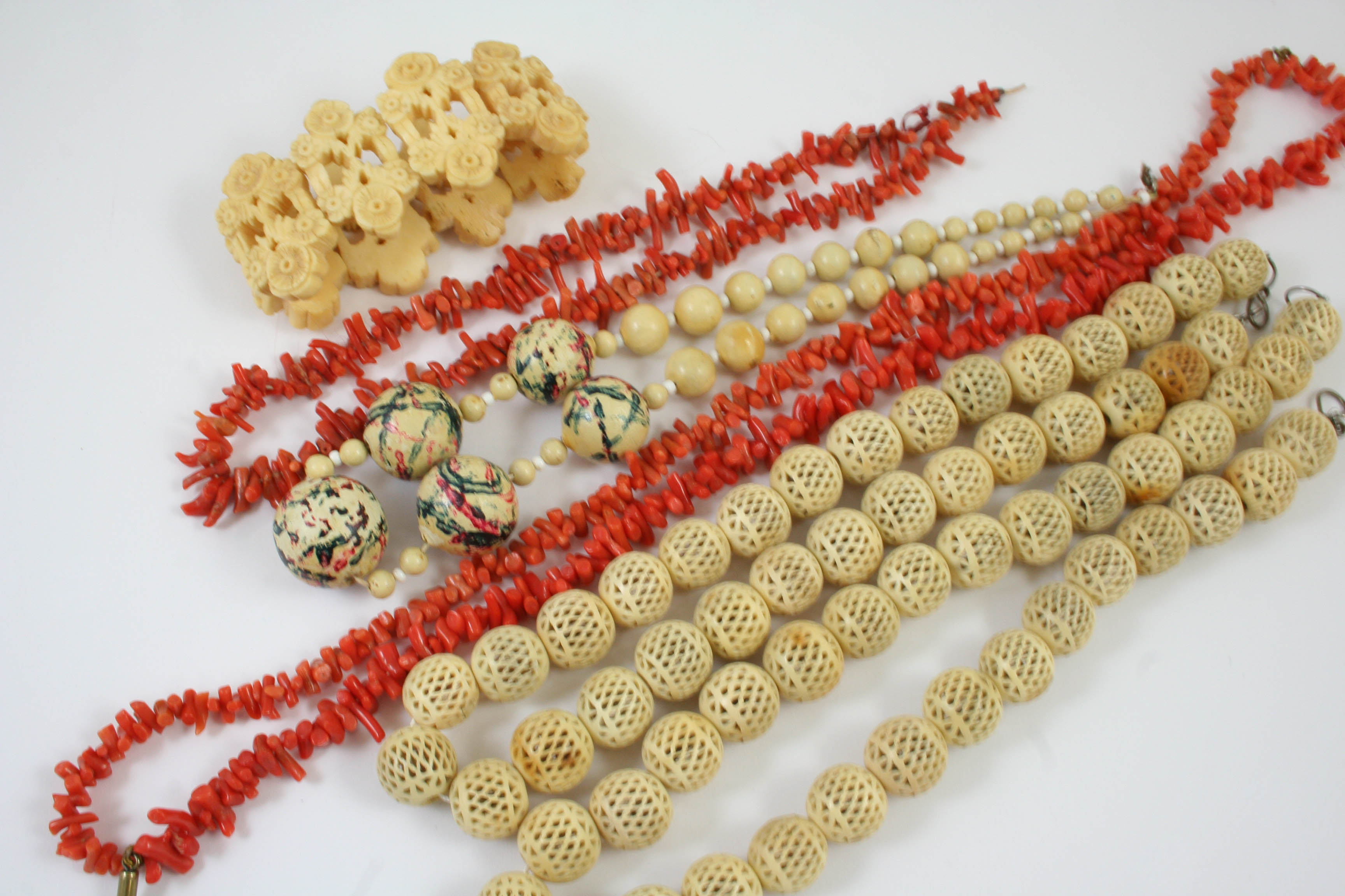 A TWO ROW CORAL NECKLACE 34cm long, together with a single row coral necklace, 38cm long and