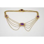 A VICTORIAN AMETHYST AND GOLD NECKLACE the five row gold chain necklace is mounted with three