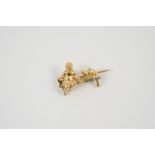 A 18CT GOLD AND DIAMOND BROOCH formed as a girl sitting on a bench with two birds, mounted with