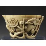 CHINESE IVORY LIBATION CUP, 18th or 19th century, the peach shaped bowl carved to the exterior