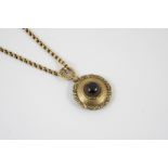 A VICTORIAN GOLD AND GARNET PENDANT the circular foliate engraved pendant mounted with a circular