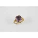 A GEORGIAN AMETHYST AND GOLD INTAGLIO RING the cushion shaped foil backed amethyst engraved with a