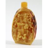 CHINESE HORNBILL SNUFF BOTTLE AND STOPPER, each side carved with a scene of figures outside a