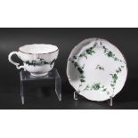BRISTOL PORCELAIN TEACUP AND SAUCER, circa 1770-80, green painted with floral swags beneath a