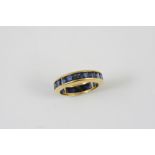 A SAPPHIRE FULL CIRCLE ETERNITY RING mounted with calibre-cut sapphires in 18ct yellow gold. Size L