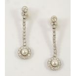 A PAIR OF DIAMOND AND PEARL DROP EARRINGS each earring set with an untested pearl within a
