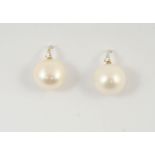 A PAIR OF CULTURED PEARL AND DIAMOND DROP EARRINGS earring set with a large pearl measuring