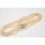 A NATURAL PEARL DOUBLE ROW GRADUATED NECKLACE the pearls graduate to a gold clasp mounted with