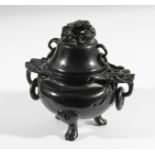CHINESE AMBER POT AND COVER, of ovoid form with bat head ring handles, scrolling paw feet and