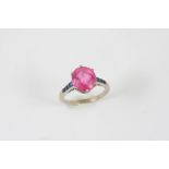 A PINK TOURMALINE AND SAPPHIRE RING BY CARTIER the oval-shaped pink tourmaline is set with four