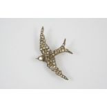 A VICTORIAN SWALLOW BROOCH set overall with graduated rose-cut diamonds, in silver and gold, 6cm