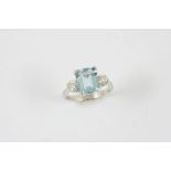 AN AQUAMARINE AND DIAMOND THREE STONE RING the step-cut aquamarine is set with two circular-cut