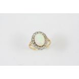 AN OPAL AND DIAMOND CLUSTER RING the solid white opal is set within a surround of old brilliant-