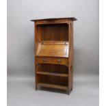 ARTS & CRAFTS OAK BUREAU with a curved top supported on slatted pillars, with a sloping lid with