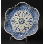 DUTCH DELFT STRAWBERRY DISH, later 18th century, of hexalobe form, blue painted with floral panels