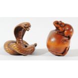 TWO JAPANESE BOXWOOD NETSUKE, in the form of a snake with glass eyes and a peach with a rat, both