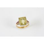 A CITRINE, RUBY AND DIAMOND DRESS RING the step-cut citrine is set with four calibre-cut rubies