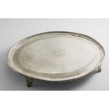 A LATE 18TH CENTURY OVAL SALVER with a reeded rim, a bright-cut border and fluted bracket feet,