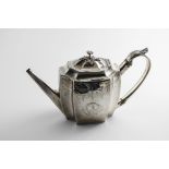 A GEORGE III ENGRAVED TEA POT of shaped rectangular outline with a leaf-capped, c-scroll handle, a