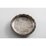 BY OMAR RAMSDEN:- A small circular dish on a collet foot, with a notched border and a hammered