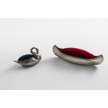 AN EDWARDIAN SILVER NOVELTY PIN CUSHION in the form of a canoe, by C. Saunders & F. Shepherd,