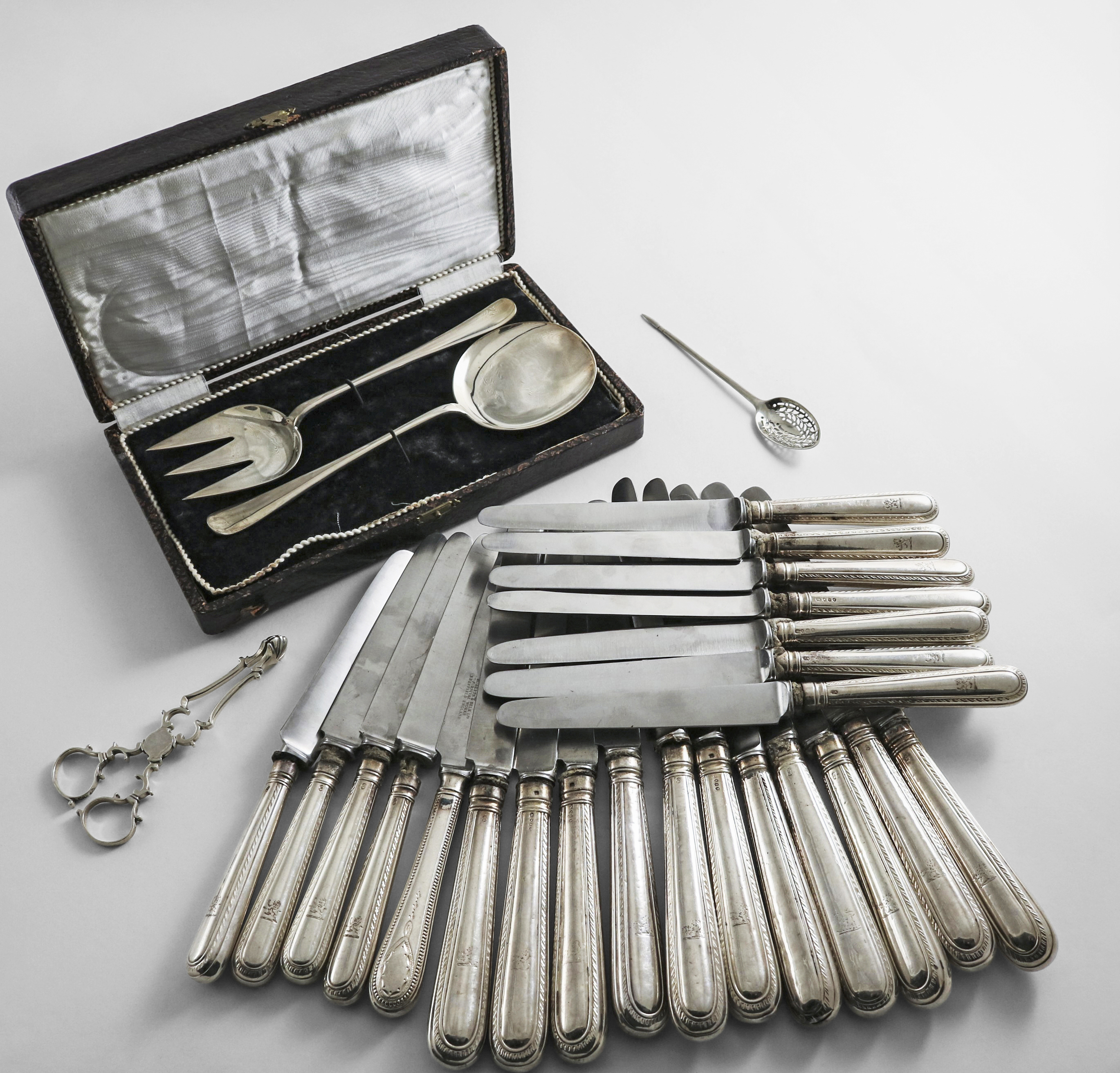 A COLLECTED OR HARLEQUIN SET OF ANTIQUE FEATHER EDGE PATTERN TABLE KNIVES and eleven side knives (