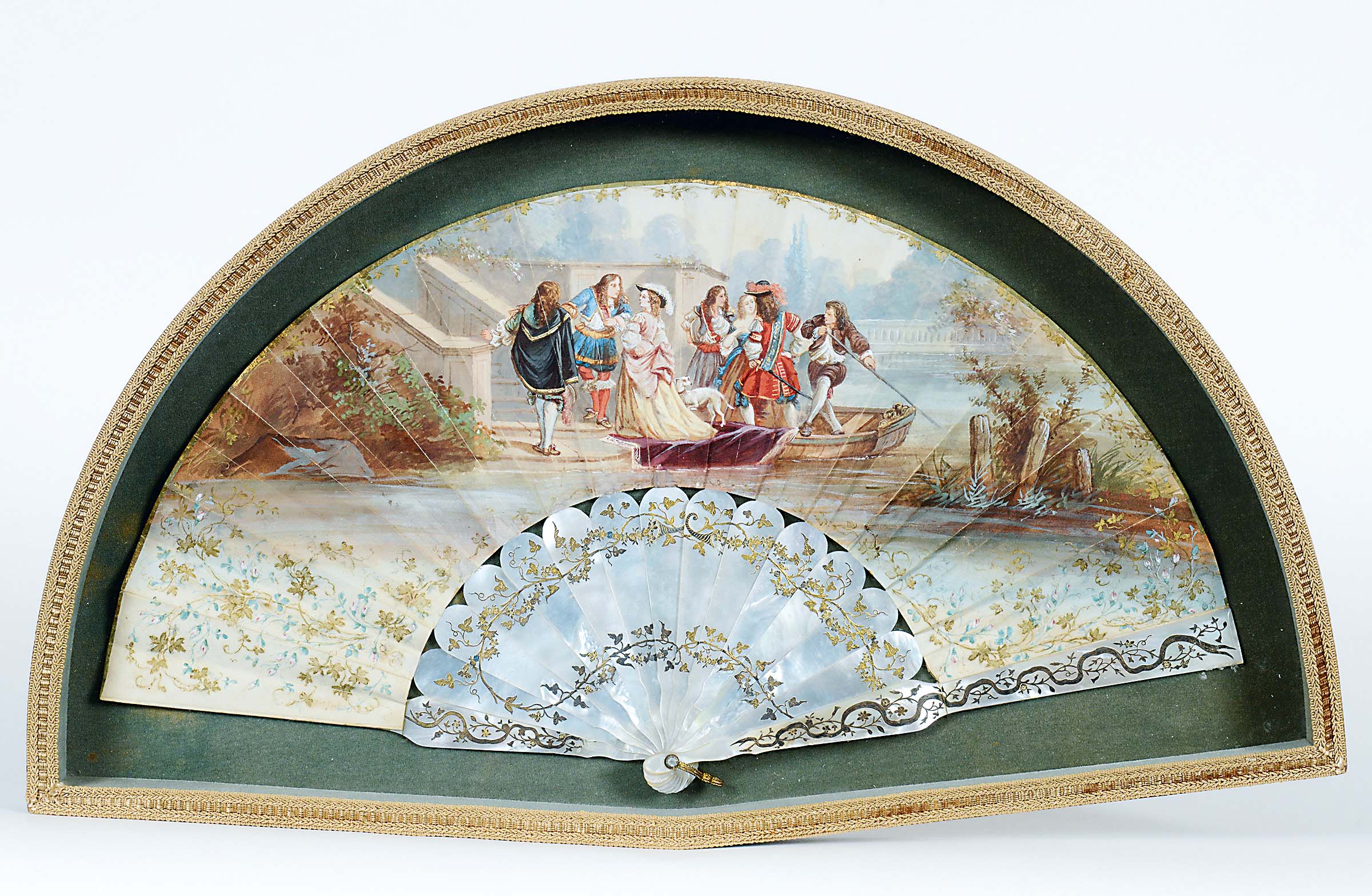 A FRENCH FAN with mother of pearl guards & sticks, engraved and gilt with trailing ivy, the paper