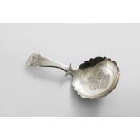 A GEORGE III CADDY SPOON with a shaped and chamfered stem and a shaped circular bowl with pricked
