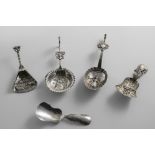 A VICTORIAN SILVER CADDY SPOON with an embossed, fan-shaped bowl and a tendril, by Hilliard &