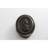 AN EARLY 18TH CENTURY OVAL HORN BOX the cover impressed with a portrait of Queen Anne,
