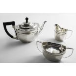 AN EARLY 20TH CENTURY THREE-PIECE TEA SET with faceted oval bodies and angular handles, by Barker