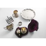 A MIXED LOT:- A small 20th century salver, initialled, a toast rack, a cream jug on button feet, a