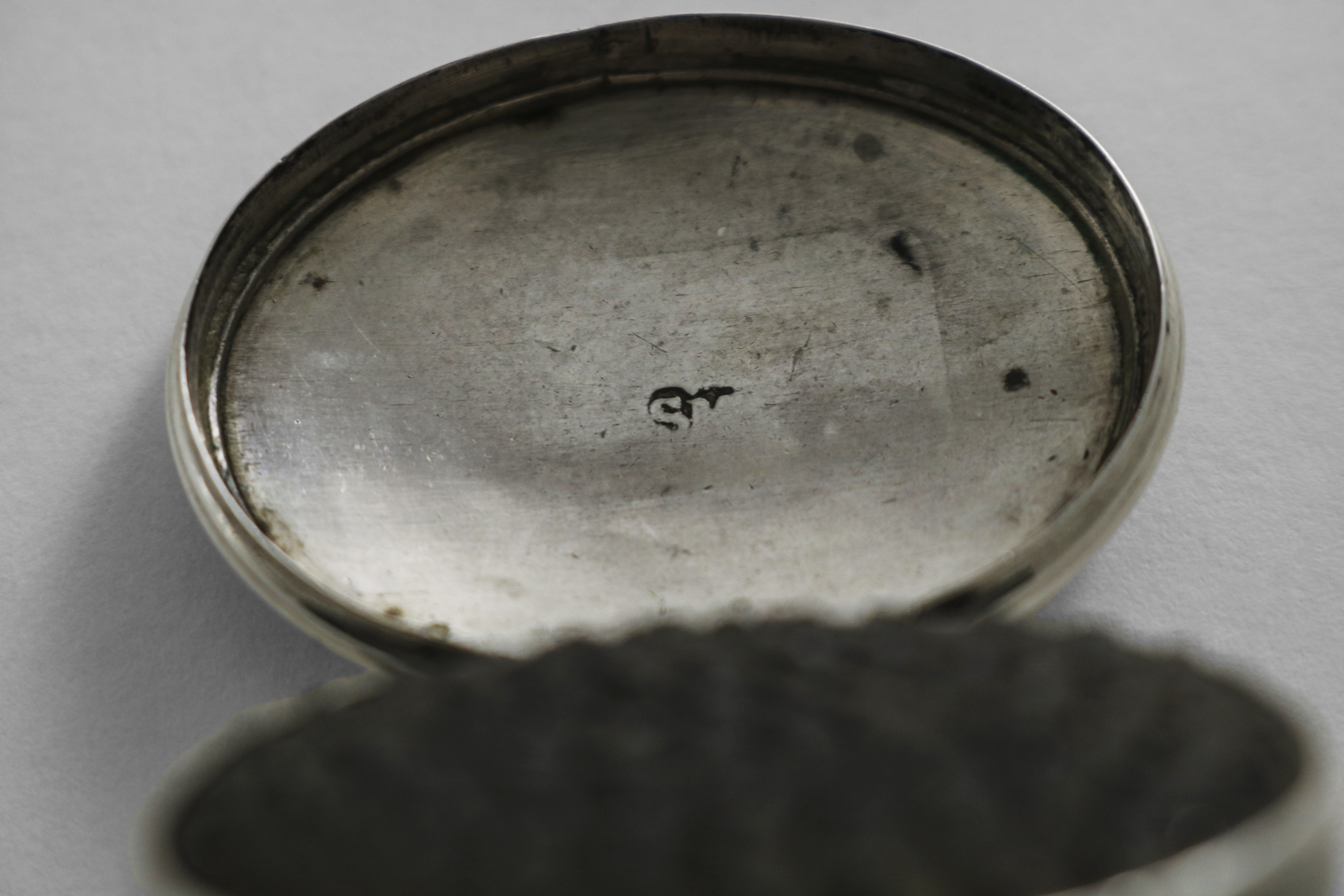 A GEORGE III IRISH NUTMEG GRATER oval with moulded borders, a hinged cover and base and a domed - Image 2 of 2