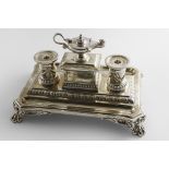 A VICTORIAN INKSTAND on a shaped rectangular base with foliate paw feet, tongue & dart borders and