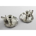 A PAIR OF WILLIAM IV CHAMBERSTICKS of shaped circular outline with flat-chased border decoration and
