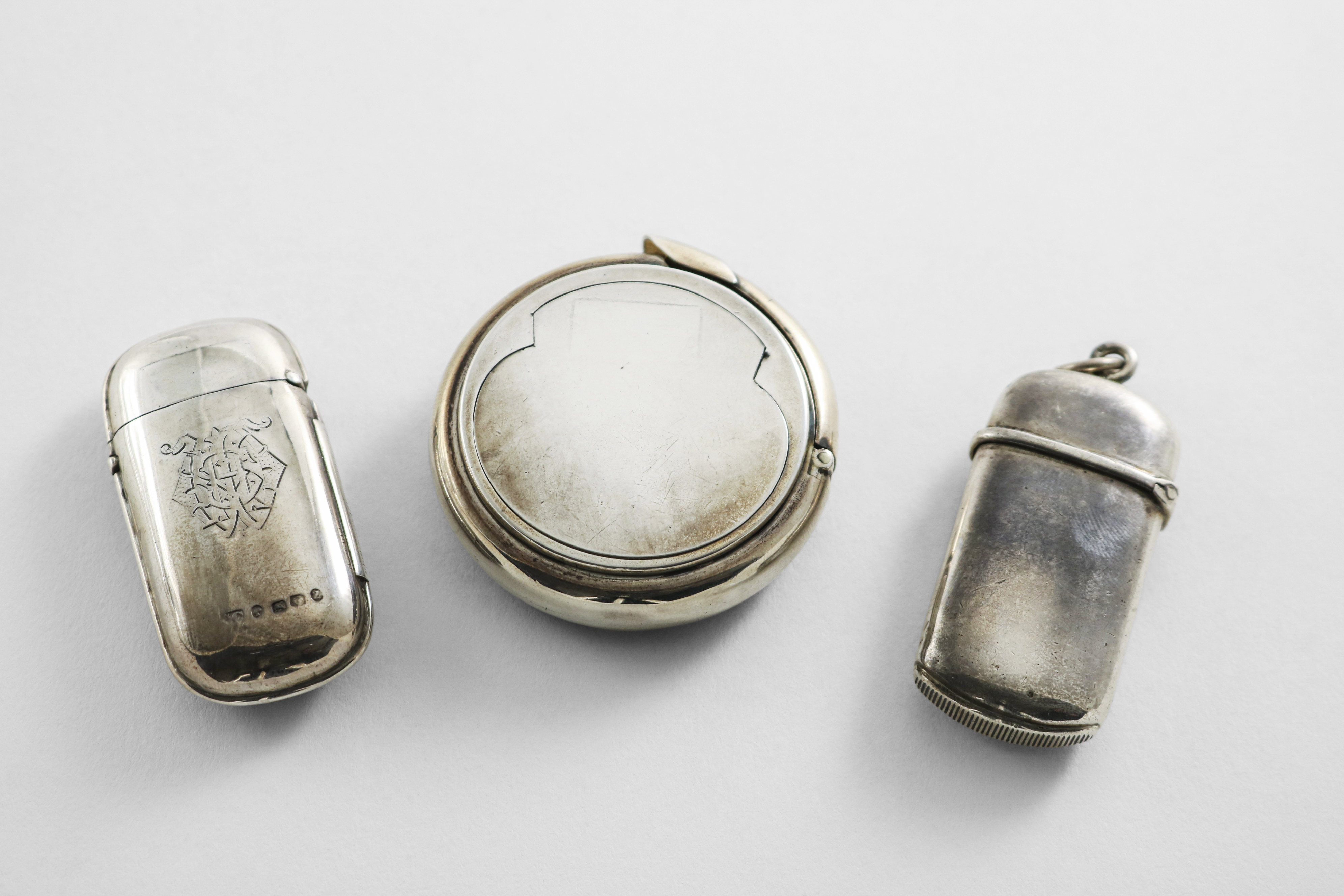 A VICTORIAN CIRCULAR SILVER VESTA CASE & SLOW MATCH HOLDER of plain circular outline with a