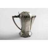 AN EDWARDIAN ARTS & CRAFTS OCTAGONAL HOT WATER JUG on a spreading foot, with an angular handle, a