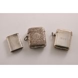 THREE LATE VICTORIAN / EDWARDIAN SILVER VESTA CASES by Sampson Mordan & Co. of London:- a plain "