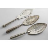 A GEORGE III FISH SLICE with a slot-pierced blade, border engraving, initialled, by Henry Chawner,