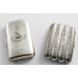 TWO LATE VICTORIAN SILVER CIGAR CASES:- One engraved and lobed to take four individual cigars,