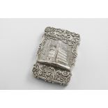 A VICTORIAN SILVER EMBOSSED "CASTLE TOP" CARD CASE of shaped rectangular outline with scroll
