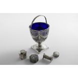 AN EDWARDIAN SWING-HANDLED SUGAR BASKET with pierced decoration, embossed foliate festoons and