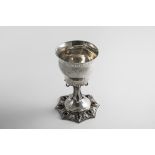 AN EARLY 20TH CENTURY HANDMADE GOBLET on an eight-sided foot, set with drop-shaped garnet cabachons,