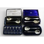 FOUR CASED SETS:- A cased pair of Continental silver gilt apostle spoons, with English import