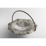 A VICTORIAN SILVER SWING-HANDLED CAKE BASKET of shaped circular outline, with a braided swing