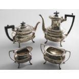 AN EARLY 20TH CENTURY FOUR-PIECE TEA & COFFEE SERVICE with rounded oblong bodies, shaped rims,