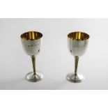 A PAIR OF LATE 20TH CENTURY LIMITED EDITION, PARCELGILT GOBLETS with textured stems, made to